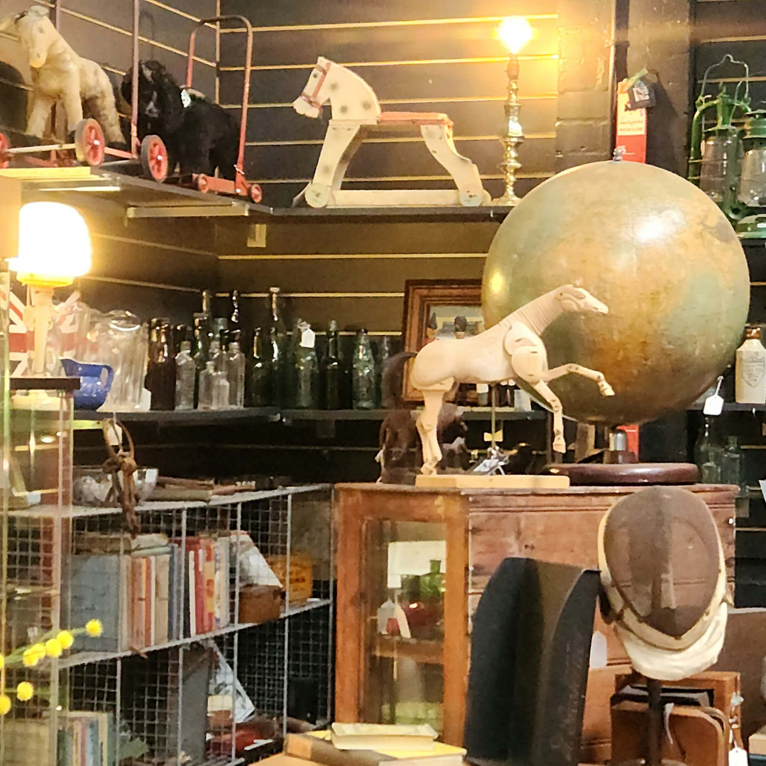toy
                      horses on shelves. A globe.