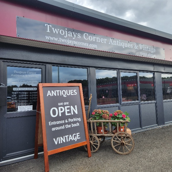 Front of
                shop showing A-board